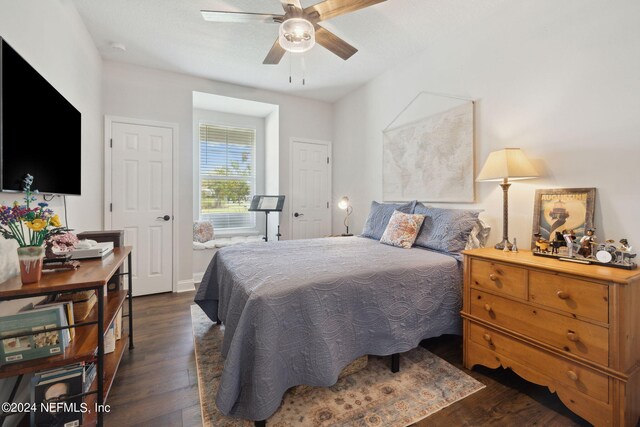 bedroom with dark wood-type flooring and ceiling fan