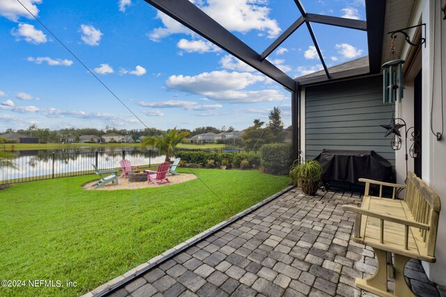 view of patio featuring a water view and a fire pit