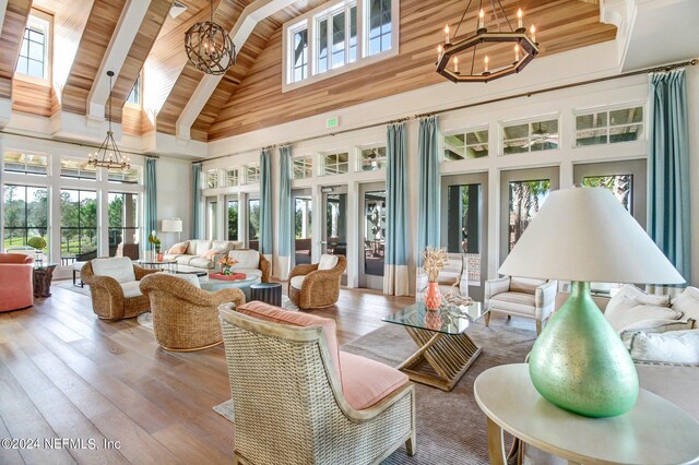 interior space with a notable chandelier, wooden ceiling, and lofted ceiling with skylight