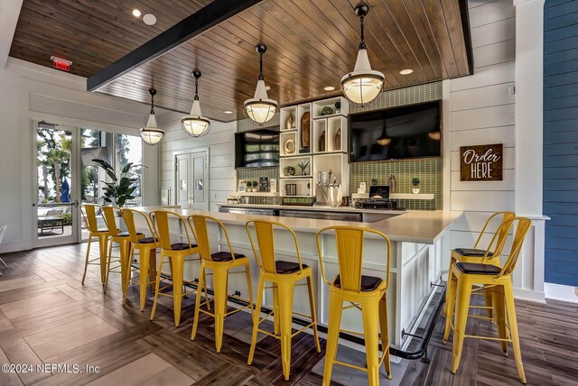 bar featuring pendant lighting, beam ceiling, tasteful backsplash, wood ceiling, and dark parquet flooring