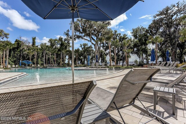 view of pool featuring pool water feature and a patio area