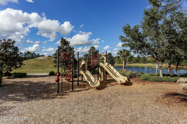 view of jungle gym featuring a water view