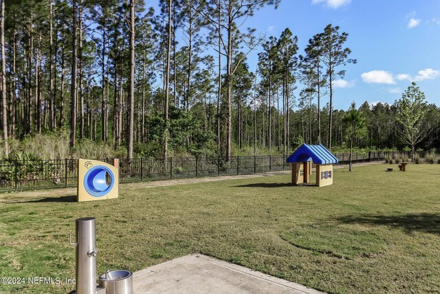 view of property's community with a lawn