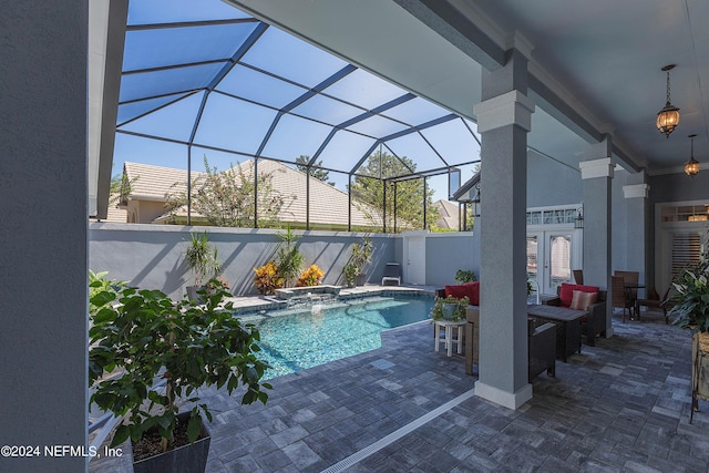 view of swimming pool with a fenced in pool, a lanai, french doors, an in ground hot tub, and a patio