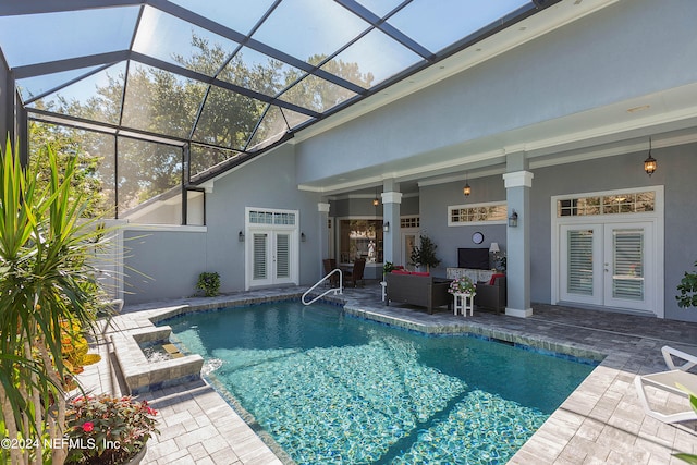 view of pool with a patio area, glass enclosure, french doors, outdoor lounge area, and ceiling fan