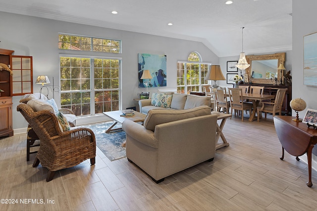 living room with light wood-type flooring, lofted ceiling, and plenty of natural light