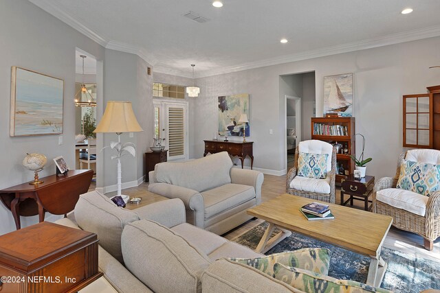 living room with crown molding and light wood-type flooring