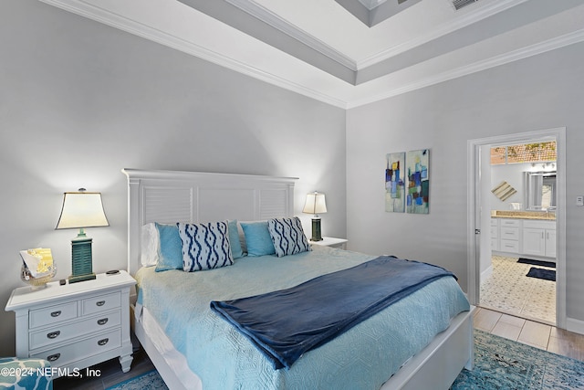 bedroom with connected bathroom, ornamental molding, and hardwood / wood-style floors