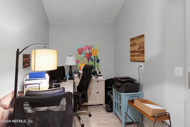 home office featuring a textured ceiling and light wood-type flooring