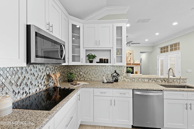 kitchen with a sink, white cabinets, and stainless steel appliances