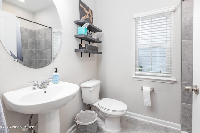 full bath with tile patterned floors, toilet, baseboards, and a sink