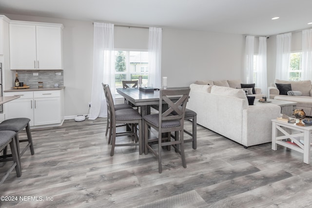 dining area with recessed lighting, plenty of natural light, and light wood-style flooring