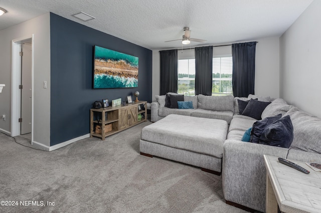 living area featuring baseboards, a textured ceiling, ceiling fan, and carpet floors