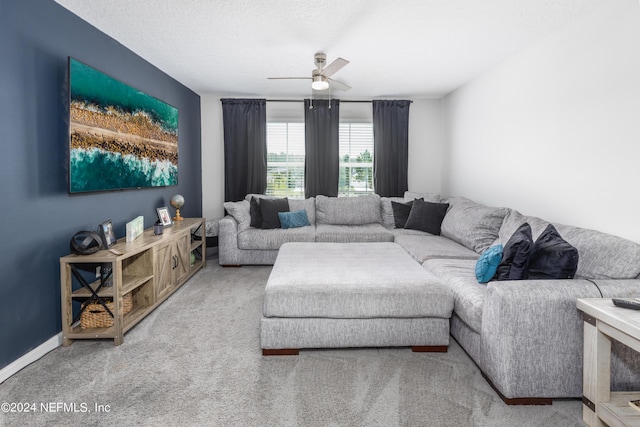 living room with baseboards, carpet, ceiling fan, and a textured ceiling