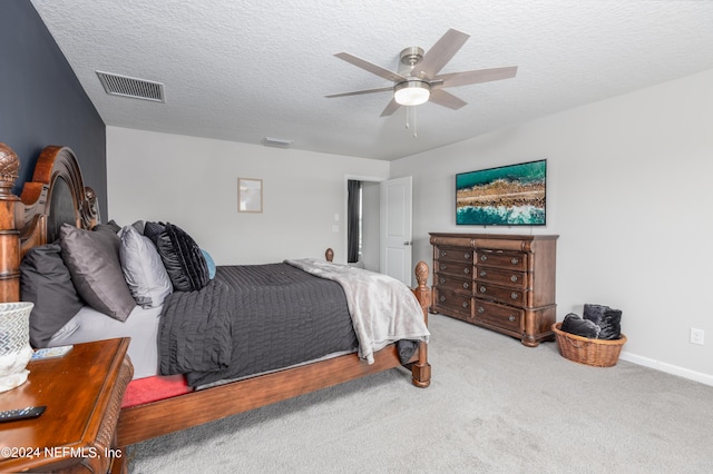 carpeted bedroom featuring visible vents, baseboards, a textured ceiling, and a ceiling fan