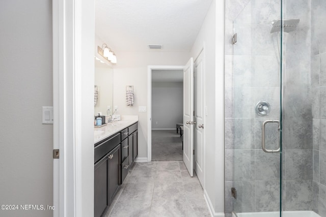 full bathroom with visible vents, a stall shower, vanity, and baseboards