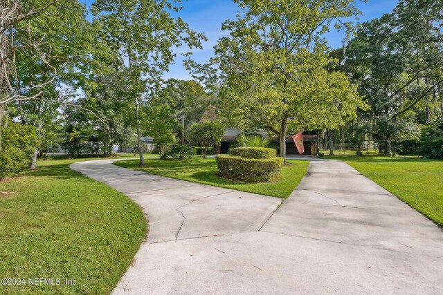 view of home's community with a lawn