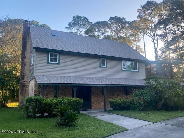 12053 Hood Landing Rd, Jacksonville, FL 32258 - view of front of home with a porch, a shingled roof, stone siding, a chimney, and a front yard
