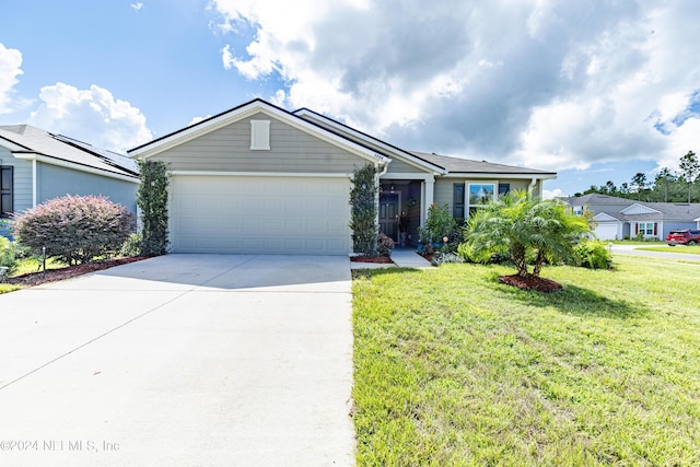 ranch-style house featuring a garage, concrete driveway, and a front yard