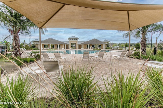 community pool featuring a patio and fence