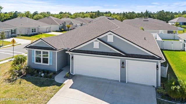 ranch-style house featuring a front yard and a garage