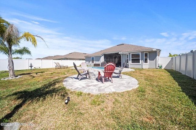 rear view of house featuring a patio and a yard