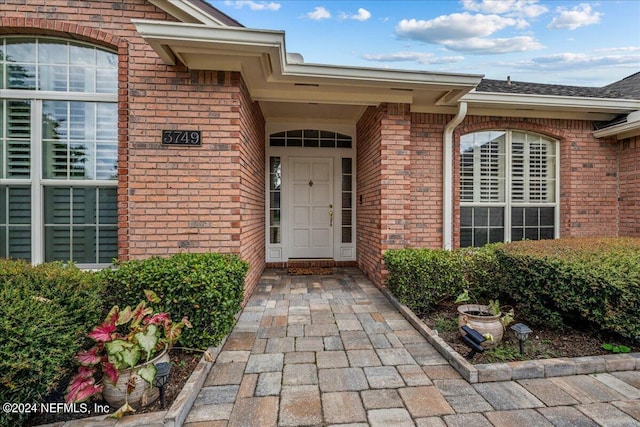 property entrance with brick siding