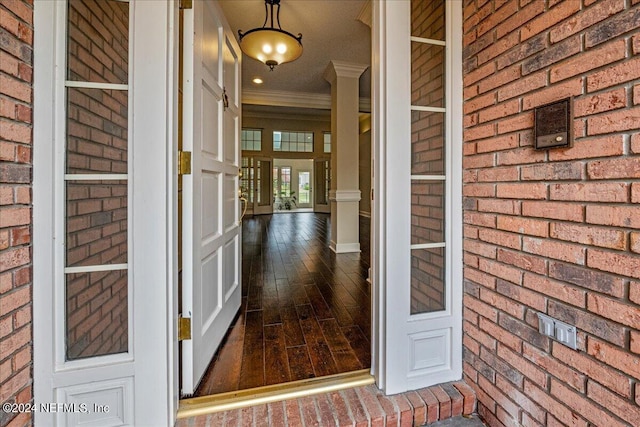 view of exterior entry featuring brick siding