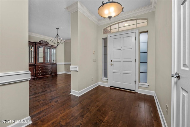 foyer entrance with ornamental molding, hardwood / wood-style floors, and baseboards