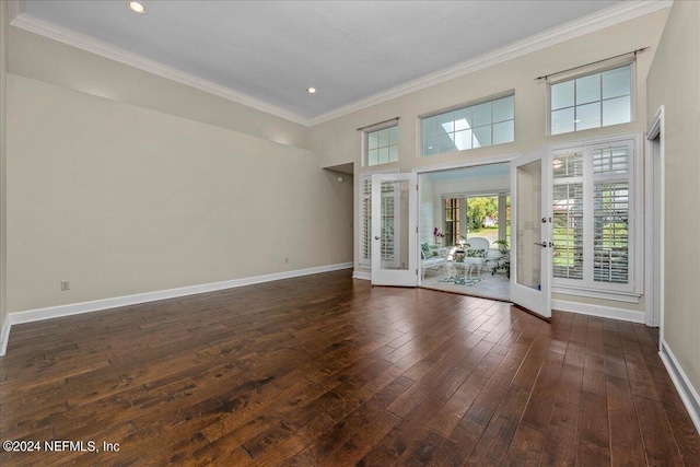 unfurnished living room with ornamental molding, dark wood-style flooring, french doors, and baseboards