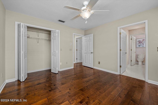 unfurnished bedroom with hardwood / wood-style flooring, baseboards, visible vents, and a closet