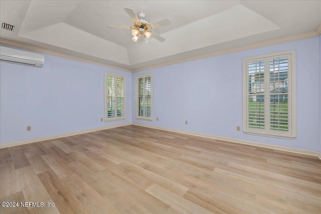 spare room featuring a raised ceiling, visible vents, and a wall mounted AC