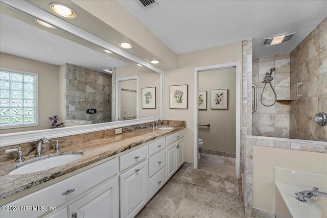 full bath with a walk in shower, toilet, a sink, visible vents, and double vanity