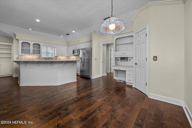 kitchen featuring decorative backsplash, appliances with stainless steel finishes, a breakfast bar area, dark wood-type flooring, and open shelves