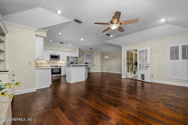 unfurnished living room with visible vents, lofted ceiling, wood-type flooring, ceiling fan, and crown molding