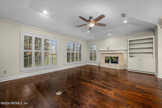 unfurnished living room featuring hardwood / wood-style flooring, a premium fireplace, visible vents, vaulted ceiling, and crown molding