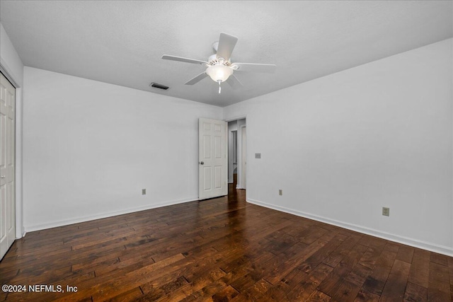 unfurnished bedroom featuring a textured ceiling, hardwood / wood-style flooring, a ceiling fan, visible vents, and baseboards