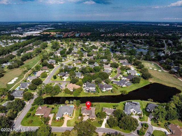 drone / aerial view featuring a water view and a residential view