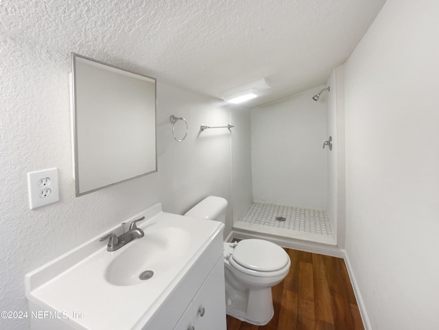 4026 Capper Rd, Jacksonville, FL 32218 - bathroom featuring toilet, wood finished floors, a textured ceiling, vanity, and a shower stall