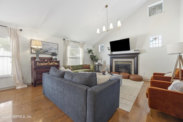 living room with wood-type flooring, a fireplace, and plenty of natural light