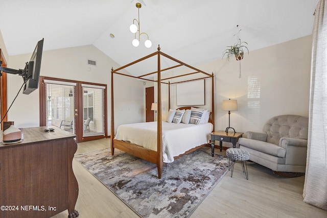 bedroom with light hardwood / wood-style floors, vaulted ceiling, and an inviting chandelier