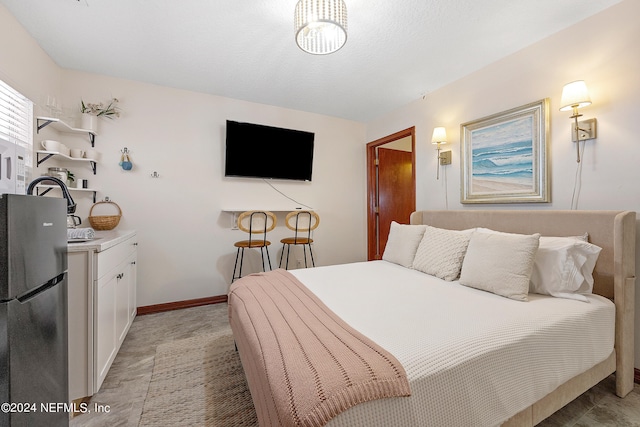 bedroom featuring stainless steel refrigerator