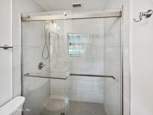 full bath featuring a stall shower, visible vents, and toilet