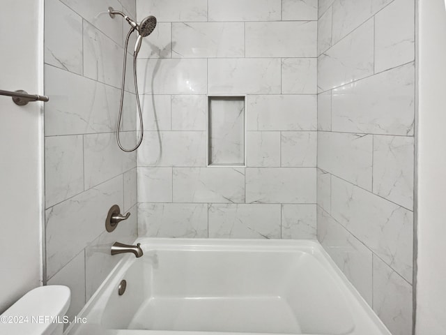 bathroom featuring  shower combination and toilet