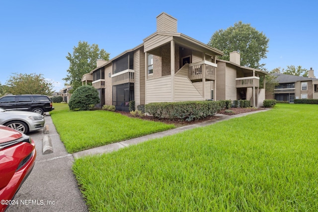 exterior space featuring a yard and a chimney