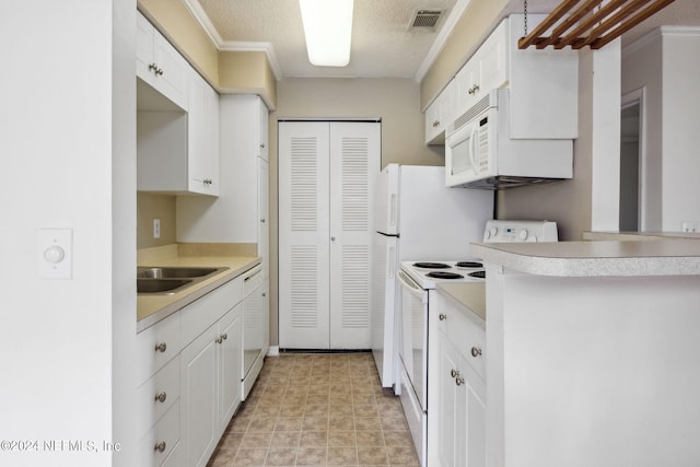 kitchen featuring light countertops, white appliances, visible vents, and white cabinetry