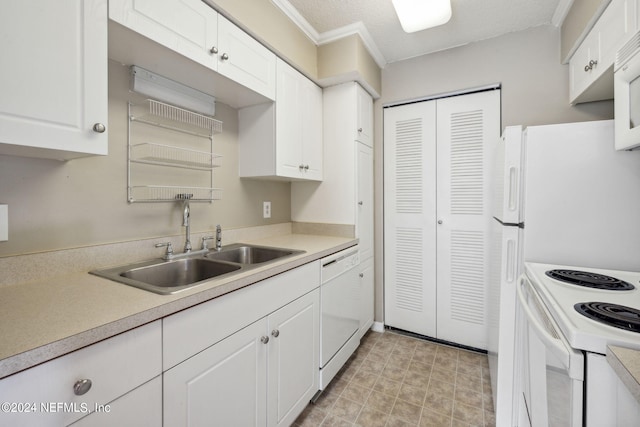 kitchen featuring white appliances, white cabinetry, light countertops, and ornamental molding