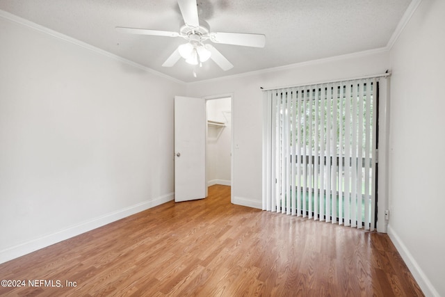 unfurnished bedroom with ornamental molding, wood finished floors, and baseboards