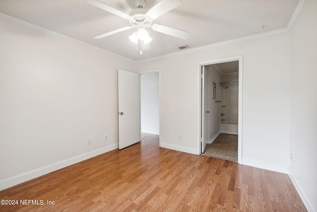 unfurnished bedroom featuring ornamental molding, light wood-type flooring, visible vents, and baseboards