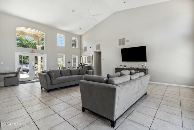 living area with french doors, visible vents, vaulted ceiling, and light tile patterned floors